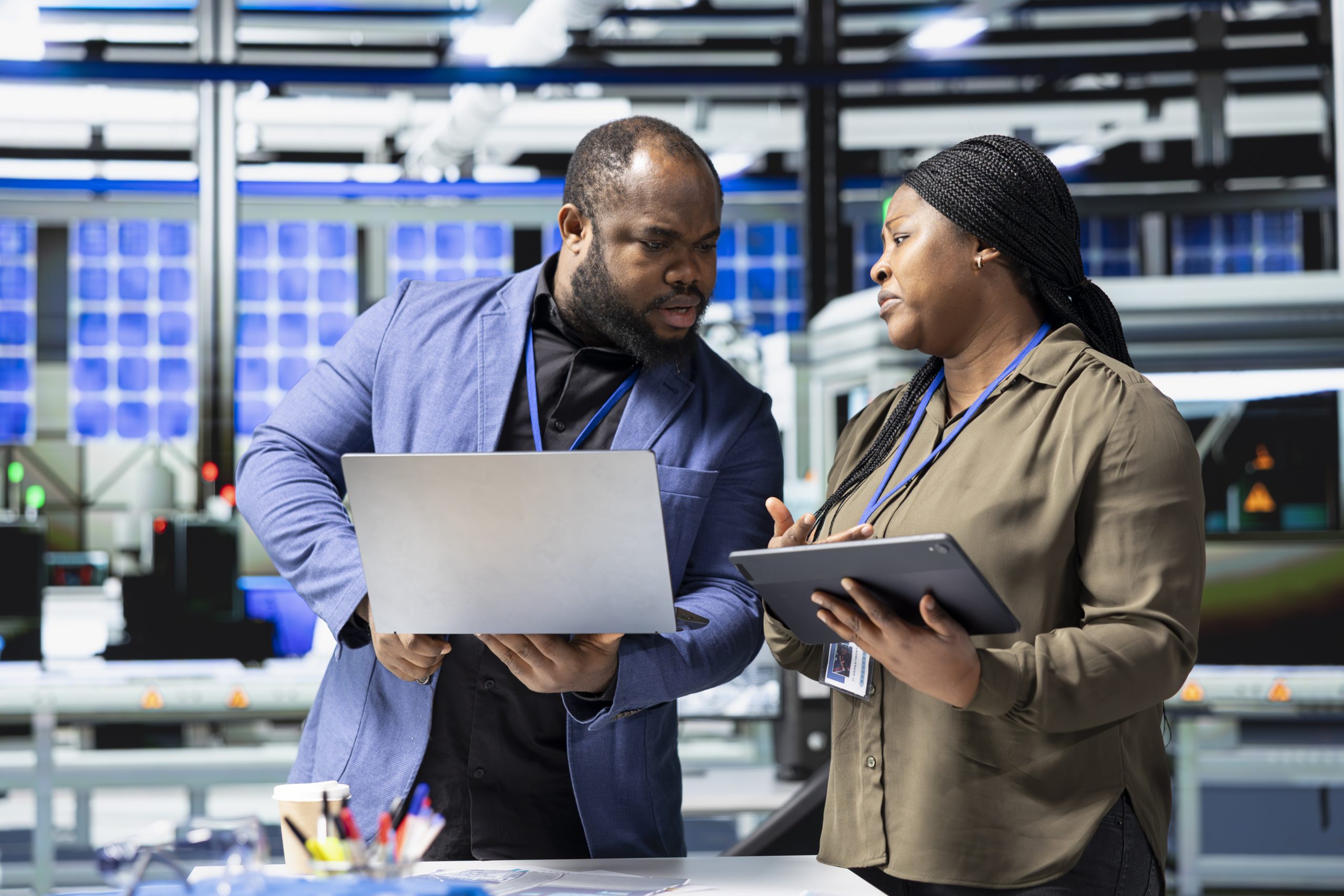 African American engineers industrial coworkers doing teamwork on production line for solar panels, combining technical insight and teamwork to drive forward clean energy infrastructure.